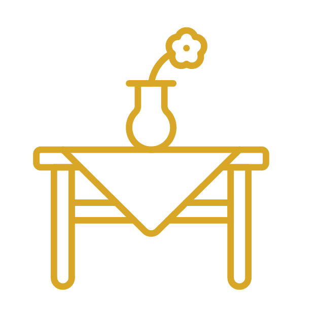 A vector drawing of a table with a tablecloth and a vase with a flower in it. 