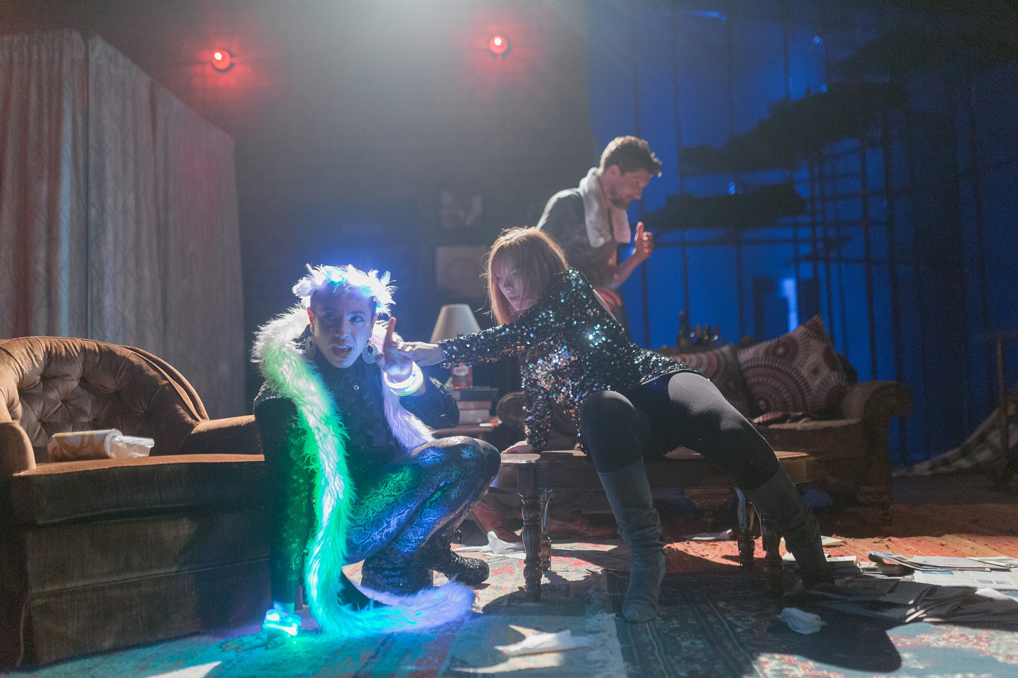 A photo of three actors in THE SIGN IN SIDNEY BRUSTEIN'S WINDOW. One wears a light-up feather boa.