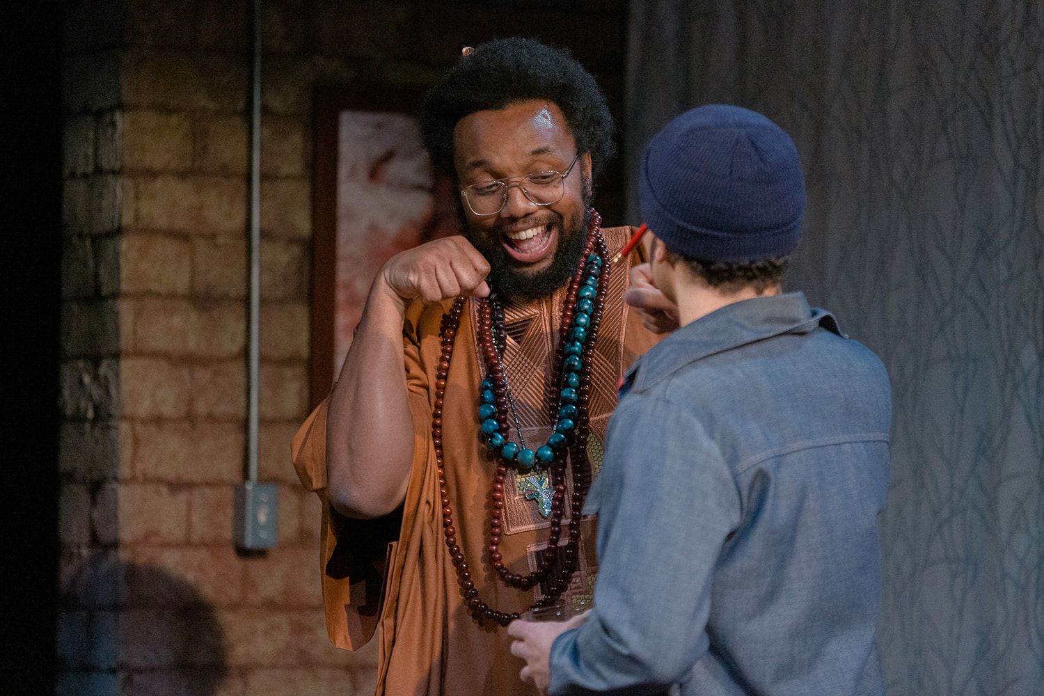 A photo of two actors bumping fists.